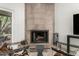Bright Living Room featuring modern fireplace, tile flooring and comfortable seating area at 9389 N 87Th Way, Scottsdale, AZ 85258