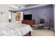 Spacious main bedroom featuring neutral carpeting, a sitting chair, and a TV at 9389 N 87Th Way, Scottsdale, AZ 85258