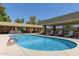 Community pool features lounge chairs, shaded picnic area and a clear swimming area at 9389 N 87Th Way, Scottsdale, AZ 85258