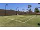 Tennis court with turf surface and surrounding fence for recreational activities at 9389 N 87Th Way, Scottsdale, AZ 85258