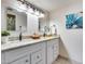 Bright bathroom features double sinks, granite counters, framed mirrors, and modern light fixture at 9450 N 94Th Pl # 116, Scottsdale, AZ 85258
