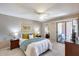 Comfortable bedroom featuring a ceiling fan and sliding door access to the private patio at 9450 N 94Th Pl # 116, Scottsdale, AZ 85258