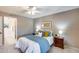 Bedroom featuring a ceiling fan, neutral walls, tile floor, and a door to the en-suite bathroom at 9450 N 94Th Pl # 116, Scottsdale, AZ 85258
