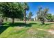 Lush green space surrounded by mature trees and community buildings at 9450 N 94Th Pl # 116, Scottsdale, AZ 85258