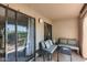 Relaxing covered patio with comfortable seating, tables, and sliding door access to the interior at 9450 N 94Th Pl # 116, Scottsdale, AZ 85258