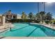 Community pool surrounded by palm trees, lounge chairs, and well-maintained landscaping at 9450 N 94Th Pl # 116, Scottsdale, AZ 85258