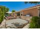 Backyard featuring a built-in grill area, a dining set, a spa, and lush landscaping at 963 S Colonial Dr, Gilbert, AZ 85296