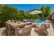 Outdoor space with a dining table, outdoor seating, pool, and lush greenery, ideal for relaxation at 963 S Colonial Dr, Gilbert, AZ 85296