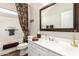 Bathroom featuring a shower-tub combo, vanity with a framed mirror, and neutral color palette at 963 S Colonial Dr, Gilbert, AZ 85296