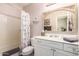 Bathroom showcasing a vanity with a decorative mirror and shower/tub combo with a marble shower curtain at 963 S Colonial Dr, Gilbert, AZ 85296
