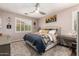 Cozy bedroom with a plush carpet, plantation shutters, and a comfortable upholstered bed at 963 S Colonial Dr, Gilbert, AZ 85296