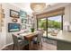 A modern dining room with a stylish light fixture, a rustic wood table and sliding door access to the patio at 963 S Colonial Dr, Gilbert, AZ 85296