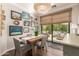 Charming dining room featuring a rustic table, four chairs and access to the covered patio at 963 S Colonial Dr, Gilbert, AZ 85296