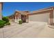 Charming single-story home featuring a tile roof, a two-car garage and an inviting blue front door at 963 S Colonial Dr, Gilbert, AZ 85296