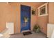 Charming covered entry with a blue front door, decorative basket, and 'Welcome Home' mat at 963 S Colonial Dr, Gilbert, AZ 85296
