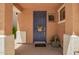 An inviting blue front door featuring a welcome mat and covered porch at 963 S Colonial Dr, Gilbert, AZ 85296