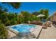 Backyard with a bubbling hot tub, dining set and green vegetation, perfect for outdoor enjoyment at 963 S Colonial Dr, Gilbert, AZ 85296