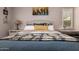 Inviting main bedroom features a comfortable upholstered bed with decorative pillows and artwork at 963 S Colonial Dr, Gilbert, AZ 85296