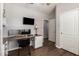 Office space with a built-in desk, hardwood floors and a flat screen tv at 963 S Colonial Dr, Gilbert, AZ 85296