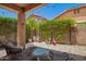 Serene covered patio with stylish furniture, enhanced by string lights and a lush green backdrop at 963 S Colonial Dr, Gilbert, AZ 85296