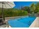 Backyard pool with a sheer descent, lush landscaping, and a serene atmosphere for relaxation at 963 S Colonial Dr, Gilbert, AZ 85296