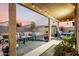Inviting covered back patio featuring cozy seating, a charming fire pit, and string lights for evening relaxation at 12026 W Salter Dr, Sun City, AZ 85373