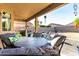 Covered patio featuring comfortable seating and a barbecue, creating an ideal space for outdoor dining and relaxation at 12026 W Salter Dr, Sun City, AZ 85373