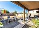 Charming covered patio with cozy seating, perfect for enjoying outdoor meals and relaxing evenings at 12026 W Salter Dr, Sun City, AZ 85373