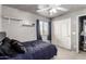Bedroom showcasing light gray walls, shelves, and a bright window view at 12026 W Salter Dr, Sun City, AZ 85373