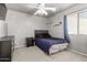 Bedroom with light gray walls, black furniture and blue accents at 12026 W Salter Dr, Sun City, AZ 85373