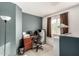 Upstairs office space with a desk and chair next to a window with brown curtains at 12026 W Salter Dr, Sun City, AZ 85373