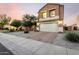 Charming home showcasing a landscaped front yard and brick driveway leading to a two-car garage at 12026 W Salter Dr, Sun City, AZ 85373