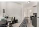 Bright hallway with carpet, white walls, and a view of the home's entrance at 12026 W Salter Dr, Sun City, AZ 85373