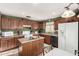 Well-equipped kitchen with wooden cabinets, modern appliances, and a functional island at 12026 W Salter Dr, Sun City, AZ 85373