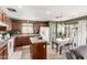 Functional kitchen with ample counter space, wooden cabinetry, and adjacent dining area at 12026 W Salter Dr, Sun City, AZ 85373
