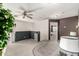 Open loft area with a ceiling fan, blue accent wall, and doorway to a bedroom at 12026 W Salter Dr, Sun City, AZ 85373