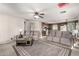 Spacious living area with a ceiling fan, neutral-toned walls, and access to the kitchen at 12026 W Salter Dr, Sun City, AZ 85373