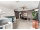 Upstairs loft area with neutral carpet, ceiling fan, and brown accent wall at 12026 W Salter Dr, Sun City, AZ 85373