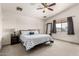 Bright Primary bedroom with a queen bed, ceiling fan, and natural light at 12026 W Salter Dr, Sun City, AZ 85373