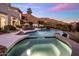 Resort-style backyard with a pool, mature landscaping, mountain views, and patio seating for outdoor enjoyment at 13631 E Windrose Dr, Scottsdale, AZ 85259