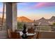 Outdoor seating area on balcony, offering stunning views of the surrounding mountains and sky at 13631 E Windrose Dr, Scottsdale, AZ 85259