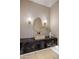 Sleek powder room featuring a unique vessel sink and an accent mirror at 13631 E Windrose Dr, Scottsdale, AZ 85259