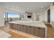 Open-concept kitchen featuring an island with pendant lighting and high-end finishes at 13631 E Windrose Dr, Scottsdale, AZ 85259