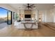 Bright living room features access to outdoor balcony and sleek ceiling fan at 13631 E Windrose Dr, Scottsdale, AZ 85259