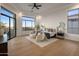 Spacious main bedroom with large windows and a ceiling fan for enhanced comfort at 13631 E Windrose Dr, Scottsdale, AZ 85259