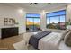 Bright main bedroom featuring a seating area and views of the surrounding desert landscape at 13631 E Windrose Dr, Scottsdale, AZ 85259