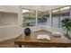Bright office space featuring hardwood floors, a writing desk, and large windows at 13631 E Windrose Dr, Scottsdale, AZ 85259