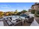 Backyard with a beautiful pool, mature landscaping, and outdoor seating area for entertaining guests or relaxing at 13631 E Windrose Dr, Scottsdale, AZ 85259