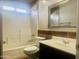 Cozy bathroom with decorative mirror, tiled walls, and shower-tub combo at 1390 E Jasper Dr, Gilbert, AZ 85296