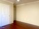 Bright bedroom featuring wood floors, ceiling fan, and neutral paint at 1390 E Jasper Dr, Gilbert, AZ 85296